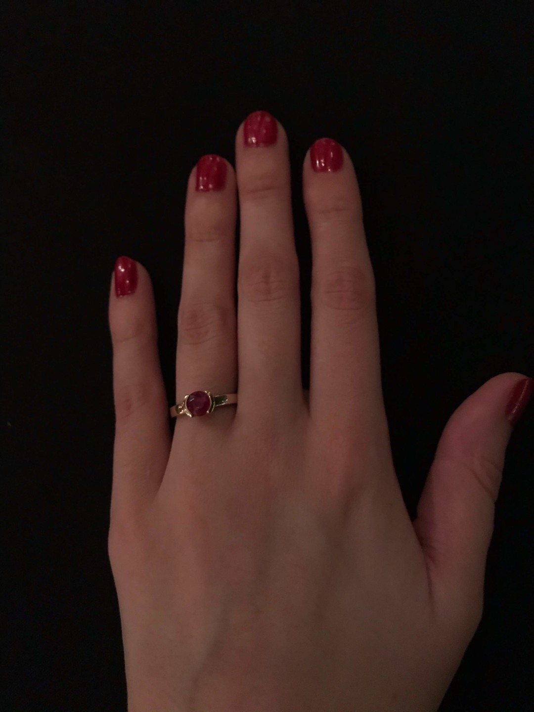 Shelby's hand with a ring on it